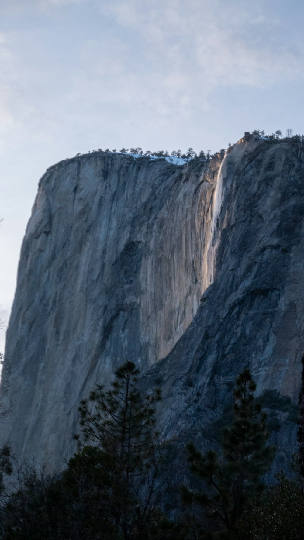 a large mountain with a very tall rock face