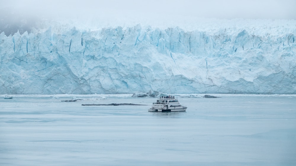 a boat in a body of water near a large glacier