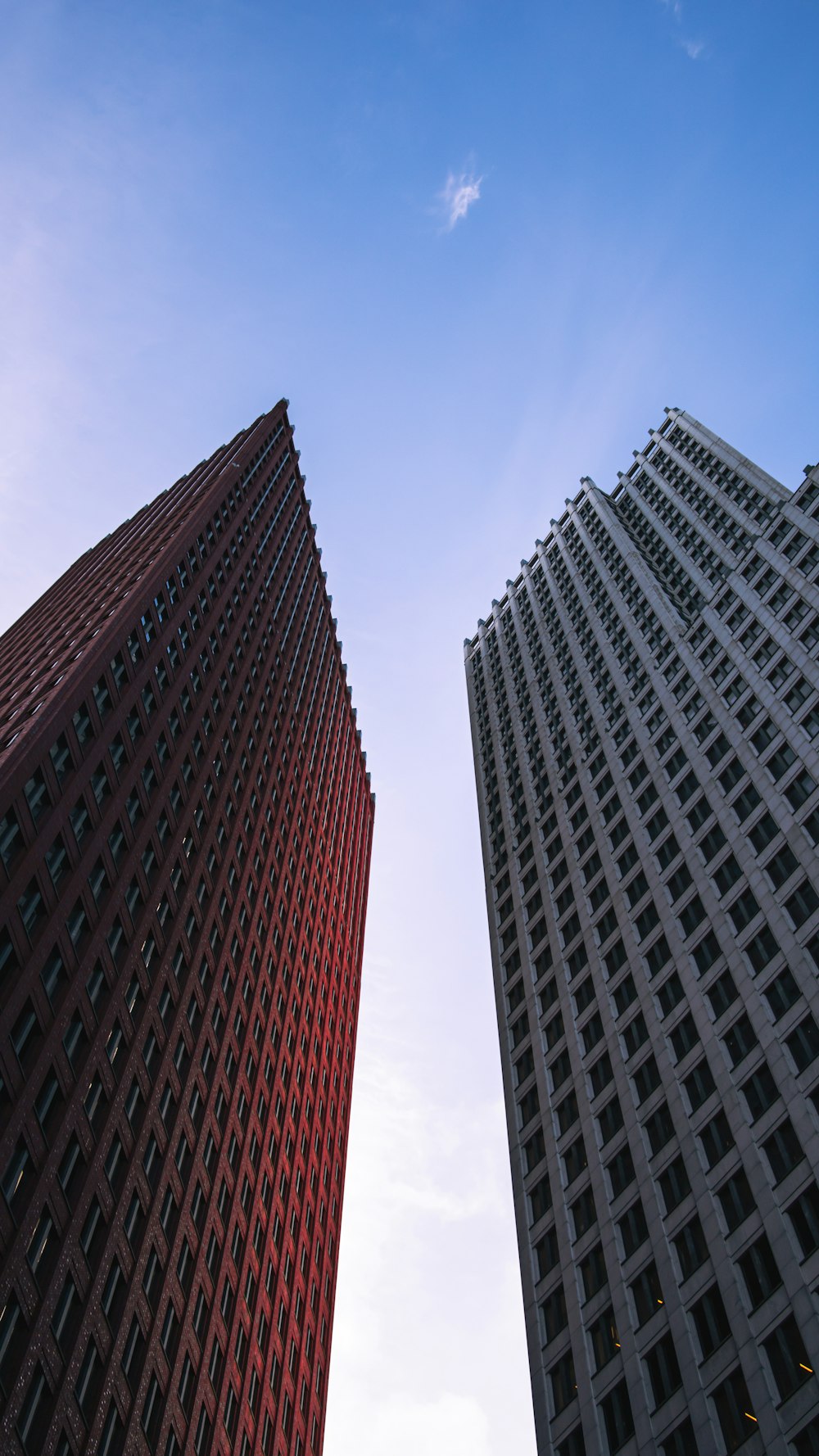 a couple of tall buildings sitting next to each other