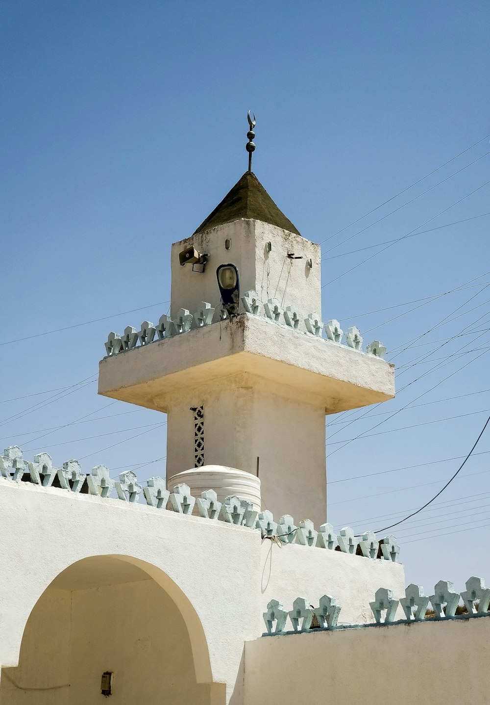 a white building with a clock on the top of it