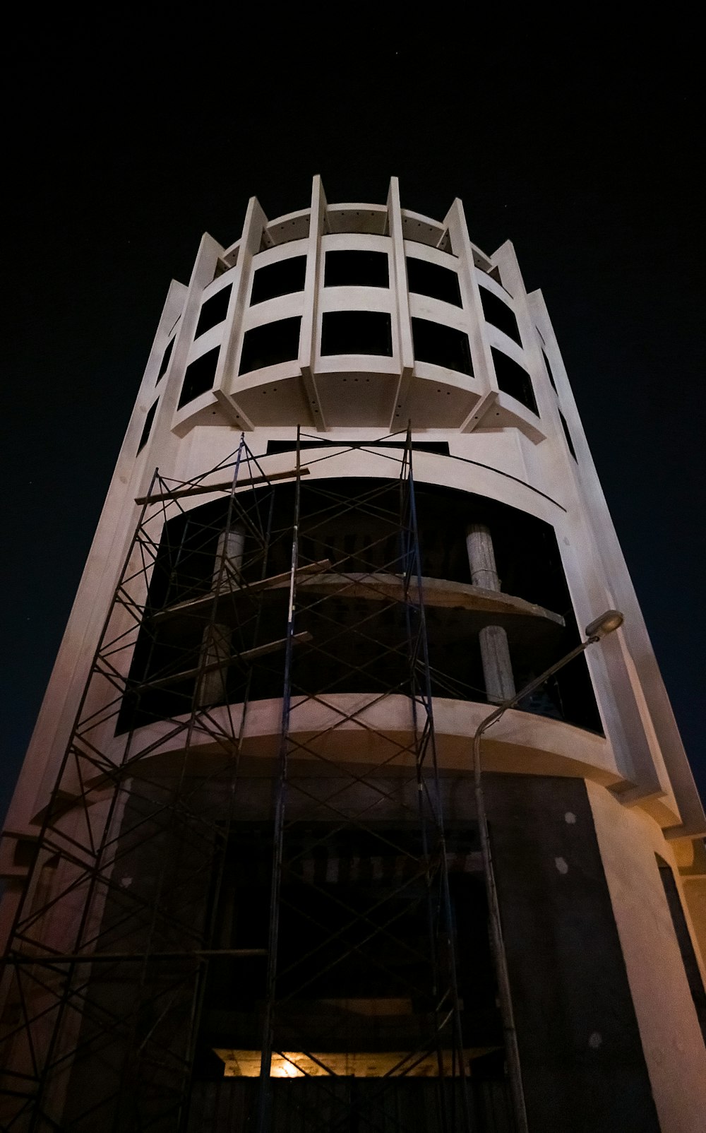 a tall white tower with a clock on it's side