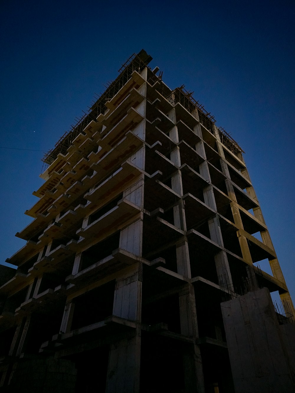 a tall building under construction with a sky background