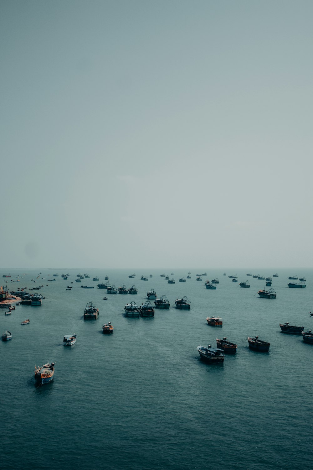 a group of boats floating on top of a large body of water