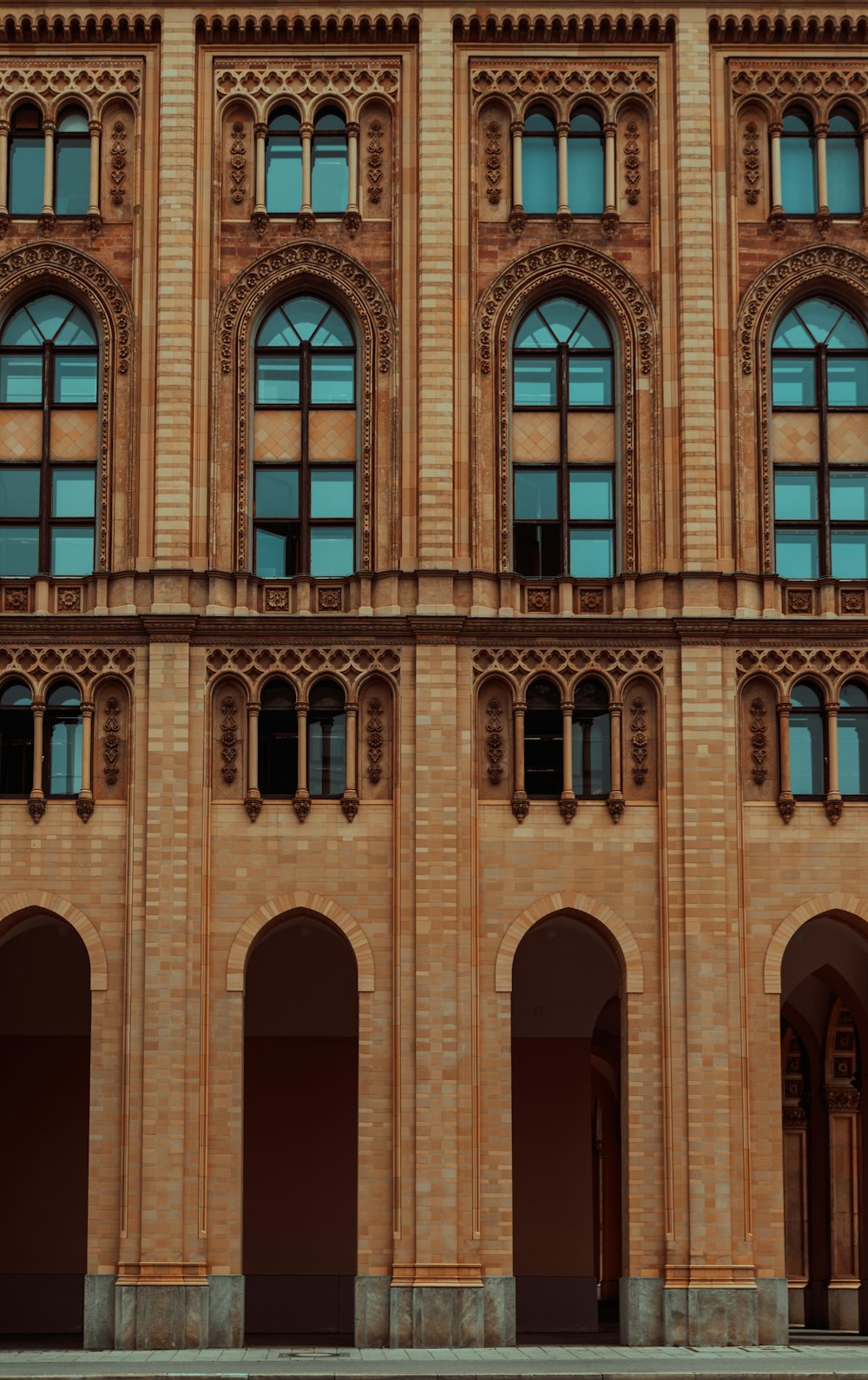 a large building with arched windows and a clock on the front of it