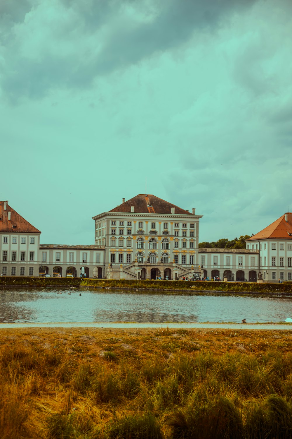 a large building sitting next to a body of water