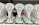 A collection of trophies with a stylized wolf head logo and the text 'European Championships 2023' displayed prominently. The trophies are arranged in neat rows, with a focus on the unique design and inscriptions in a foreign script. Each trophy is placed on a black base, and there are ribbons and medals attached at the bottom.