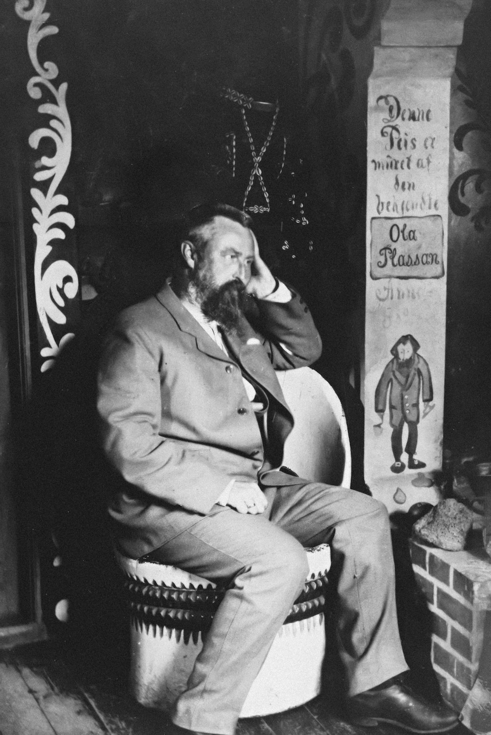 a black and white photo of a man sitting in a chair