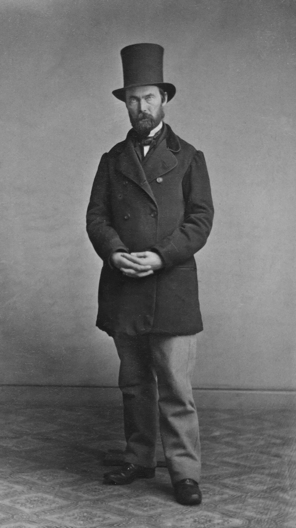 a black and white photo of a man in a top hat