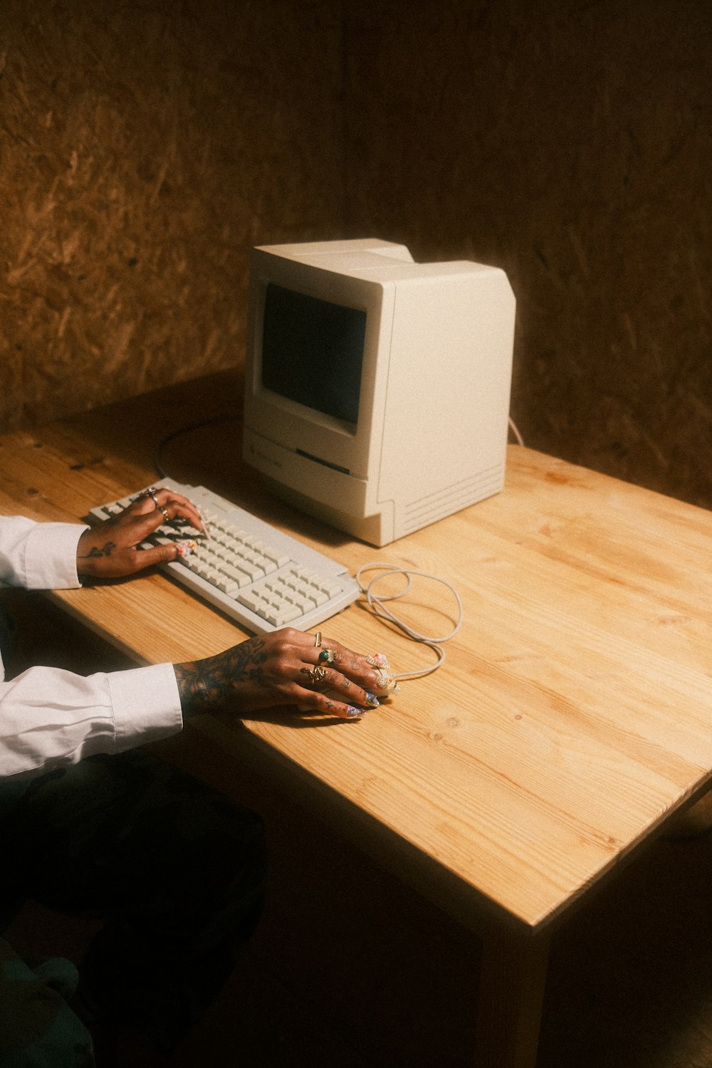 a person sitting at a desk with a computer