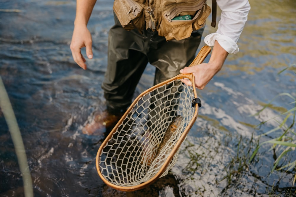 a man standing in a river holding a net