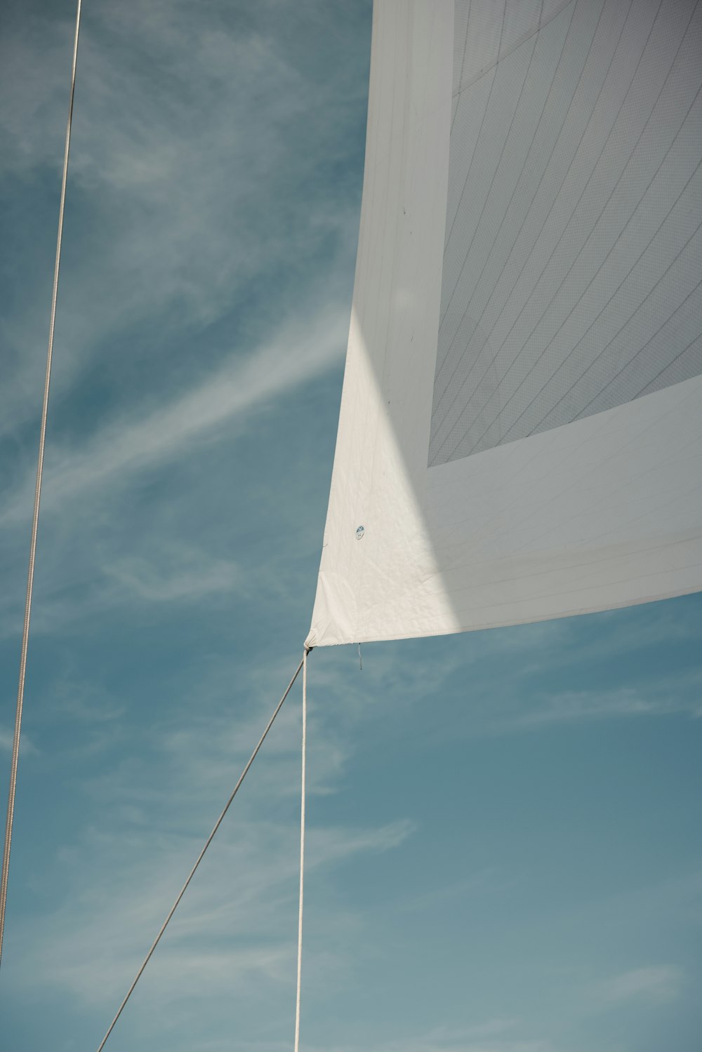 a sail boat sails in the wind on a sunny day