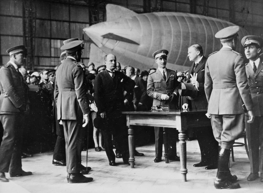 a group of men standing next to each other in front of a plane