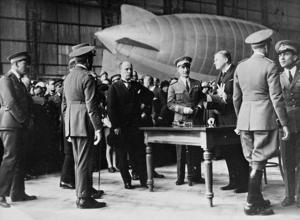 a group of men standing next to each other in front of a plane