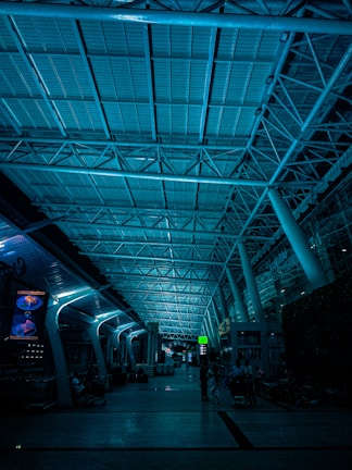 Team assembling illuminated signage equipment at an airport terminal.