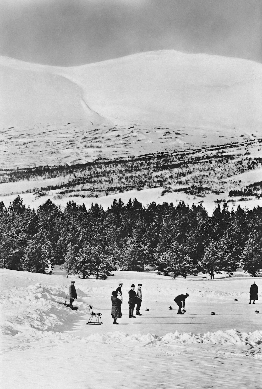 a group of people standing on top of a snow covered slope