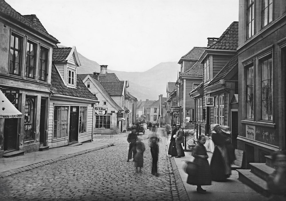 a black and white photo of people walking down a street