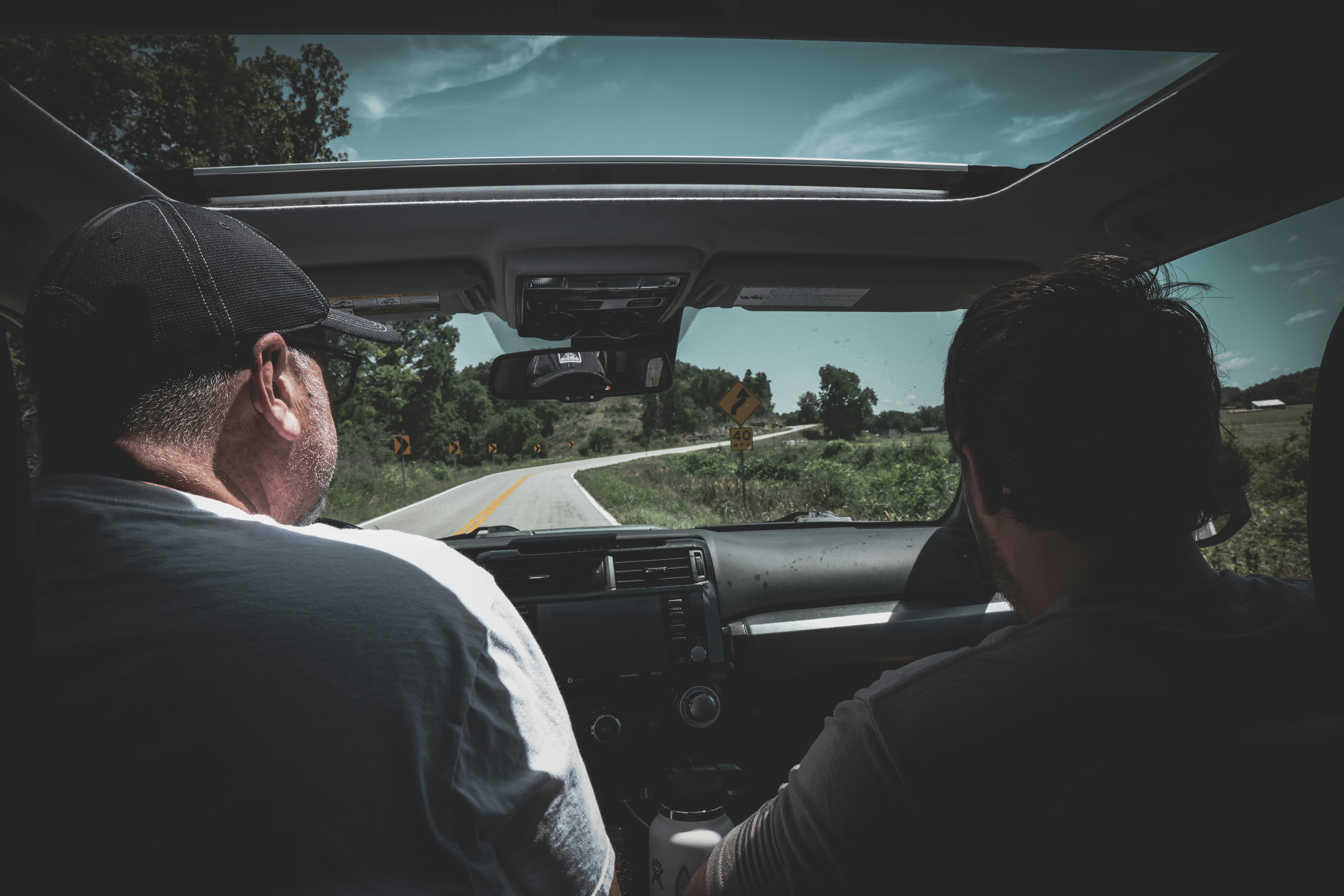 Two people sharing the driving on a road trip, showcasing the additional driver benefit - costco car rental