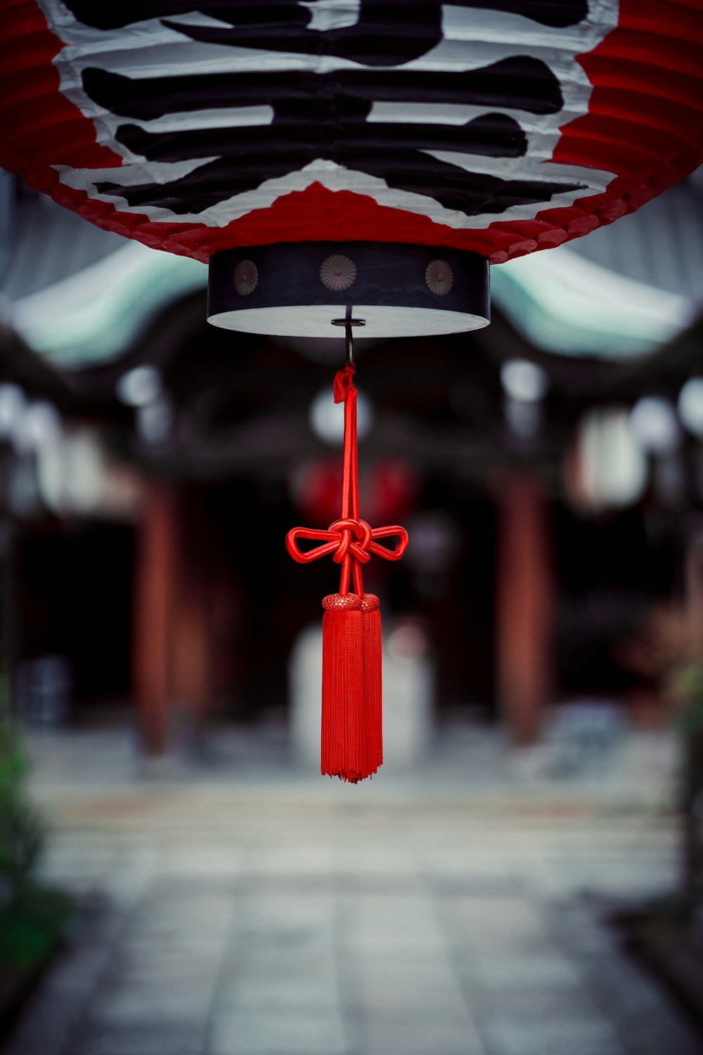 a red lantern hanging from the ceiling of a building