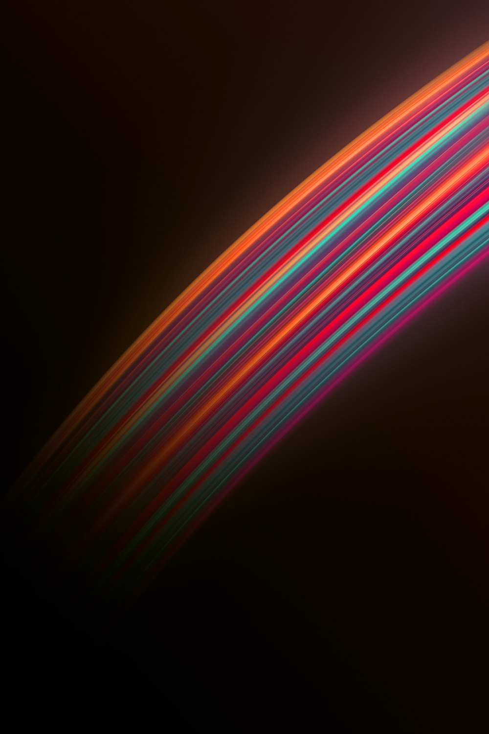 a black background with a multicolored strip of light
