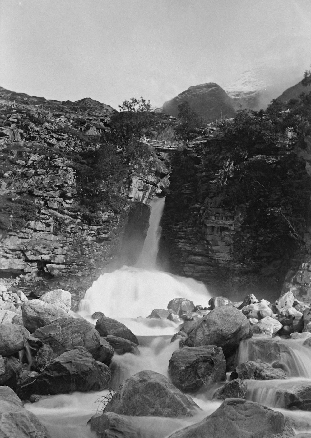 a black and white photo of a waterfall