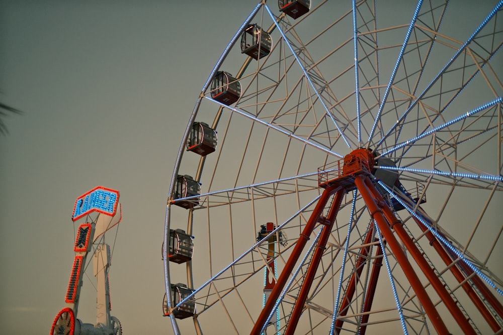 a large ferris wheel sitting next to a tall ferris wheel