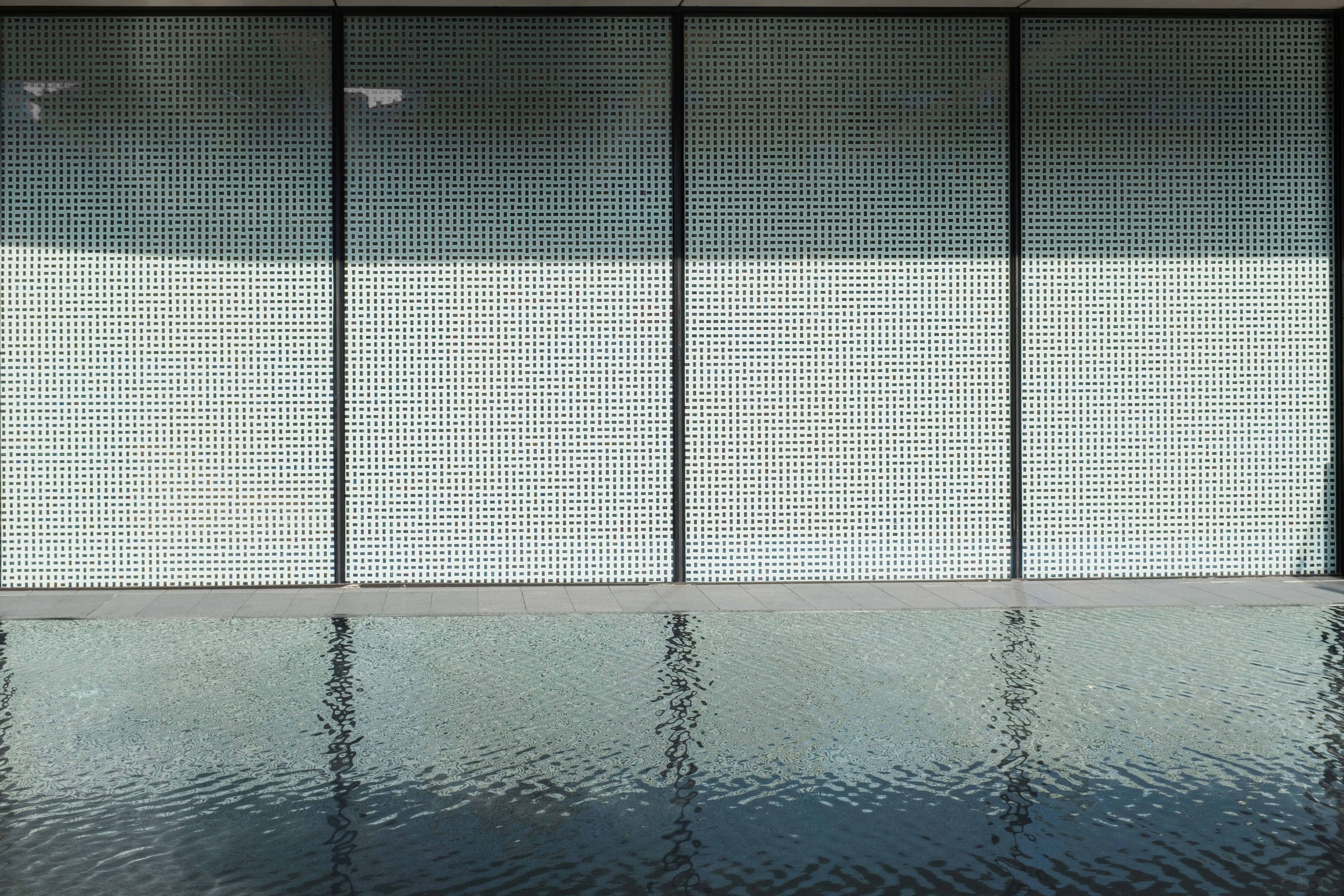 a reflection of a building in a pool of water