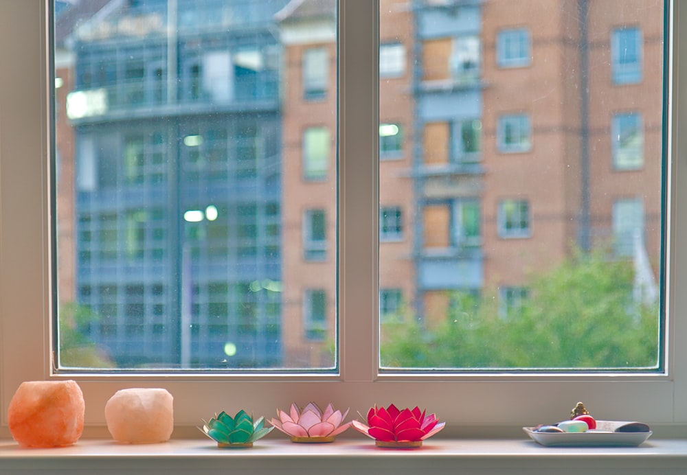 a window sill with a couple of vases on top of it