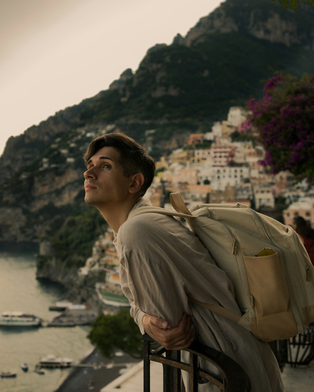 a man with a backpack standing on a balcony