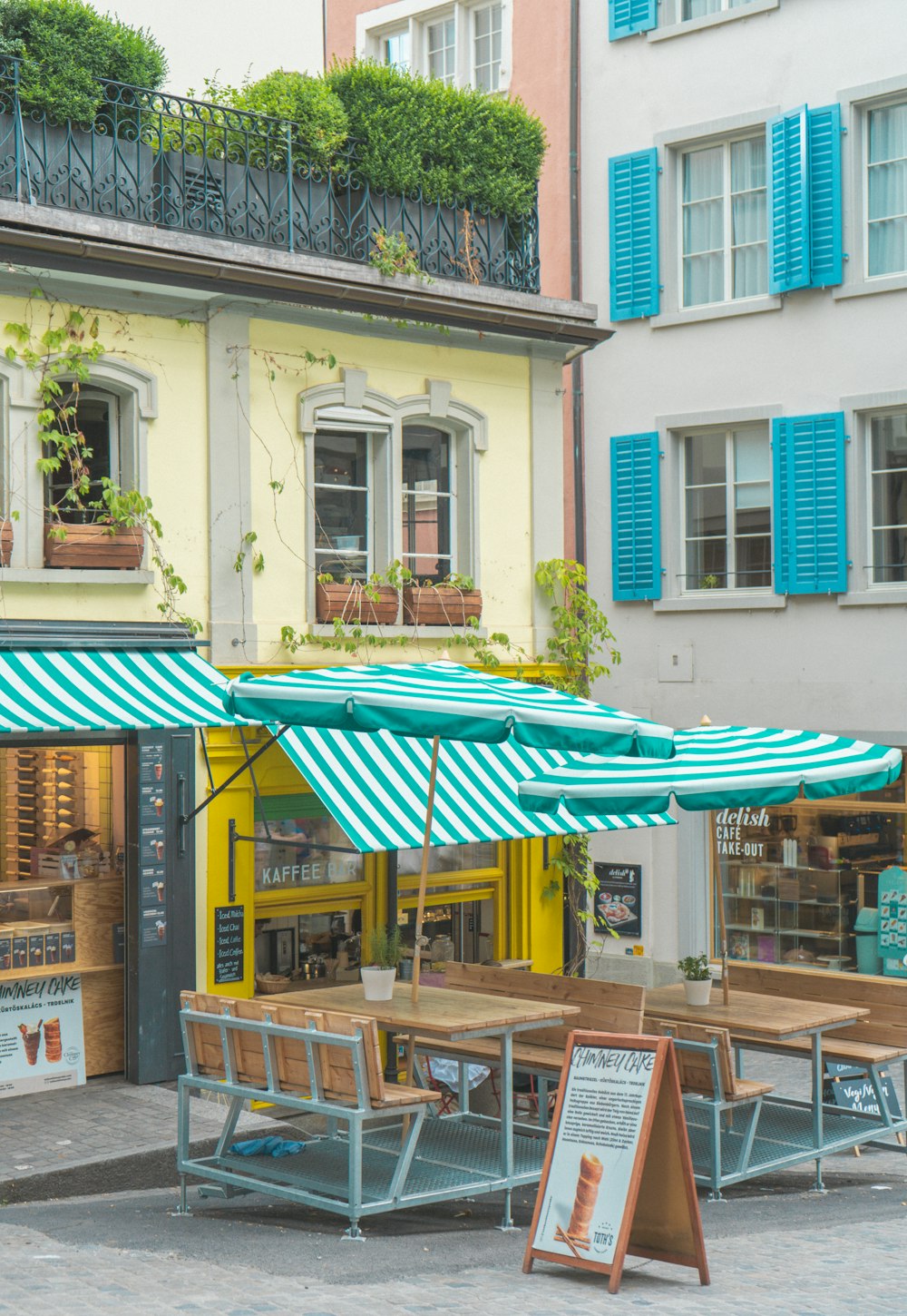 a couple of tables that are under some umbrellas