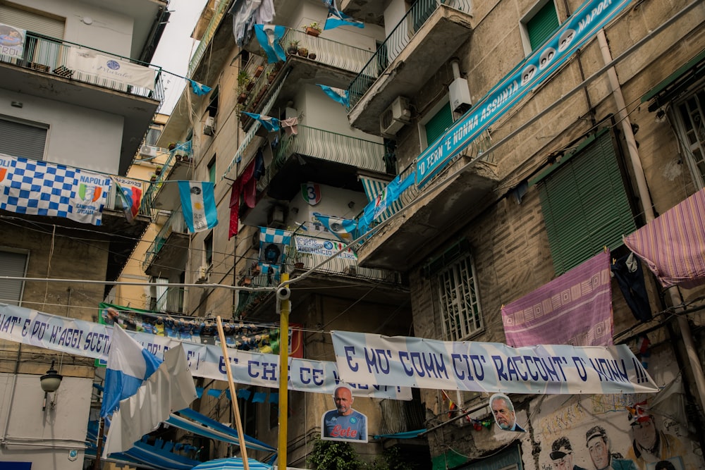 a banner hanging from a building in a city