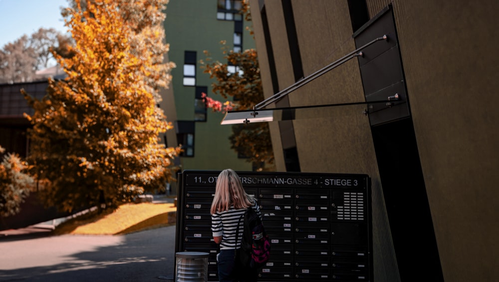 a woman is standing in front of a building