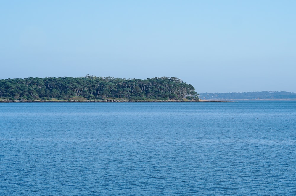 a large body of water with a small island in the distance