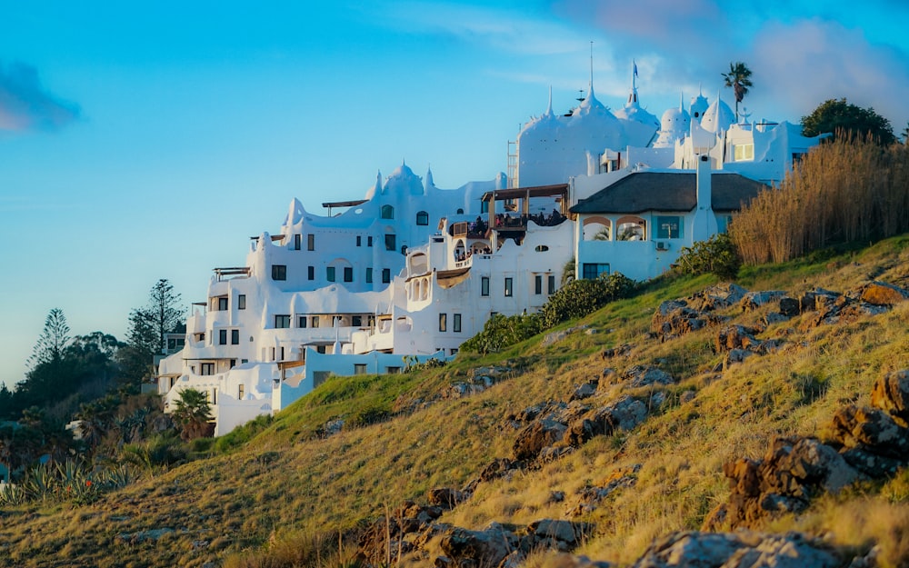 a hill with a bunch of white buildings on top of it