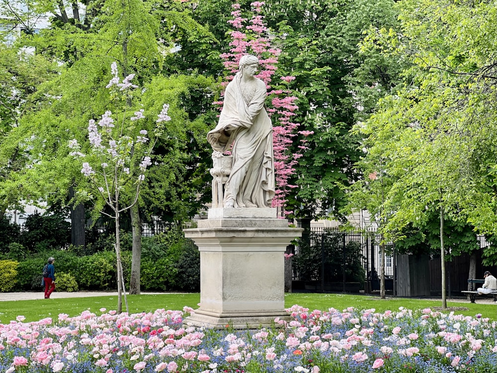 a statue of a woman surrounded by flowers