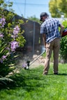 a man using a lawn mower to cut grass