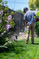 a man using a lawn mower to cut grass