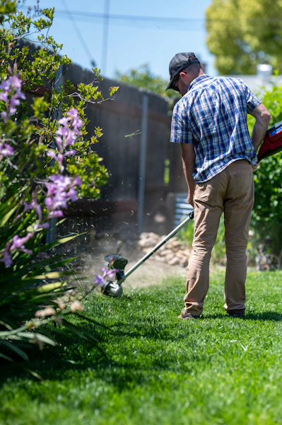 Greenline crew member trimming edges during a seasonal property cleanup
