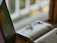 A serene study corner with Quran and notebook, softly lit by warm natural light.