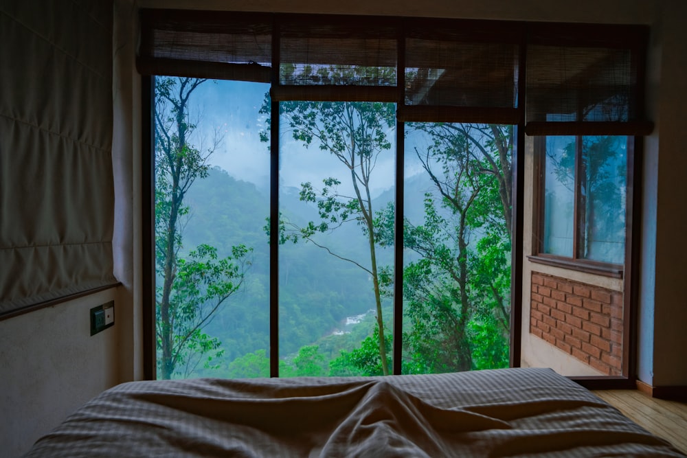 a bedroom with a view of the mountains outside the window