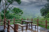 a wooden deck with a table and two benches