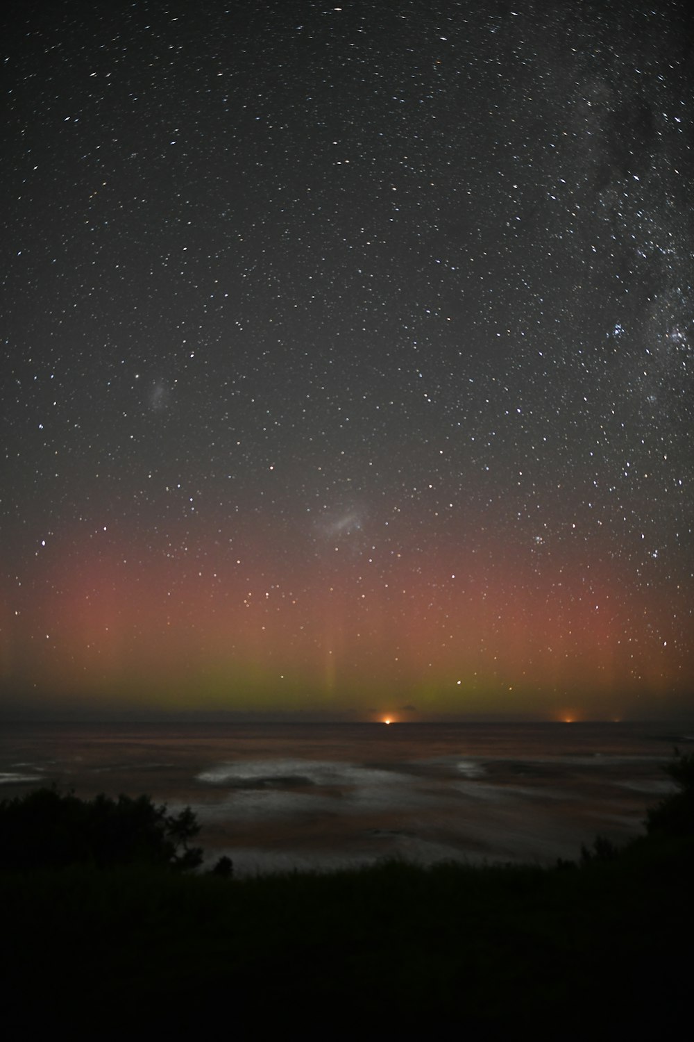 a view of the night sky with stars and the aurora