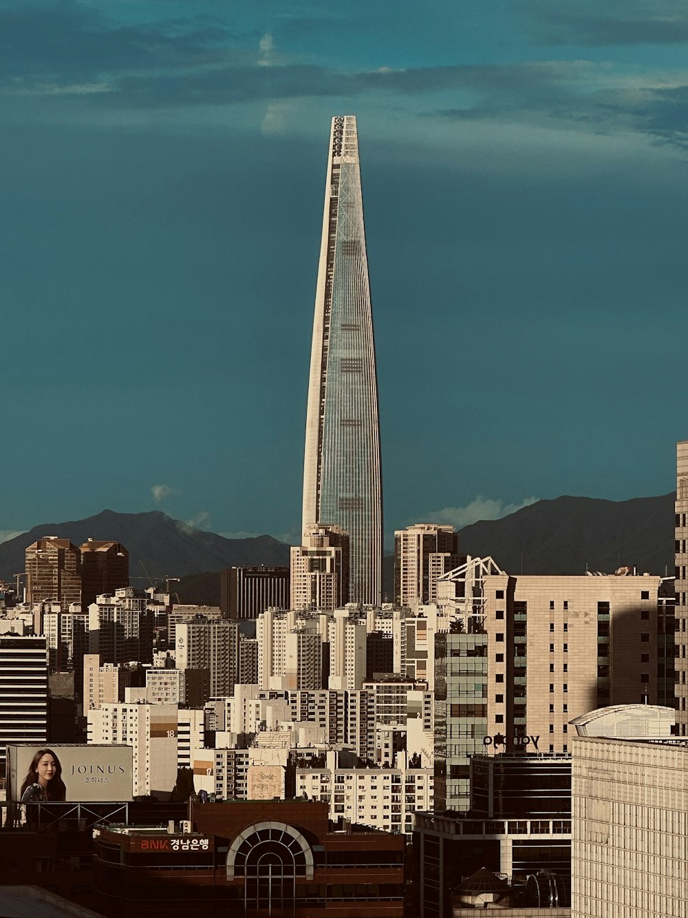 a very tall building towering over a city