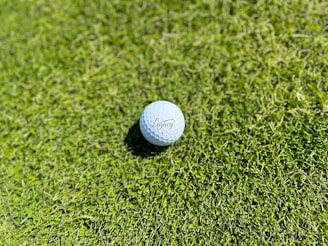 SAAG Inc image of a golf ball sitting on top of a lush green field