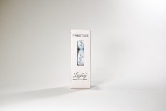 A package labeled 'Prestige' containing a single golf ball with the word 'Legacy' written on it. The packaging is white with a transparent section displaying the ball. The overall design is minimalist and sleek.