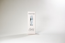 A package labeled 'Prestige' containing a single golf ball with the word 'Legacy' written on it. The packaging is white with a transparent section displaying the ball. The overall design is minimalist and sleek.