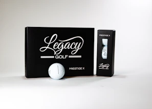 A neatly arranged display of various golf balls and tees on a wooden table