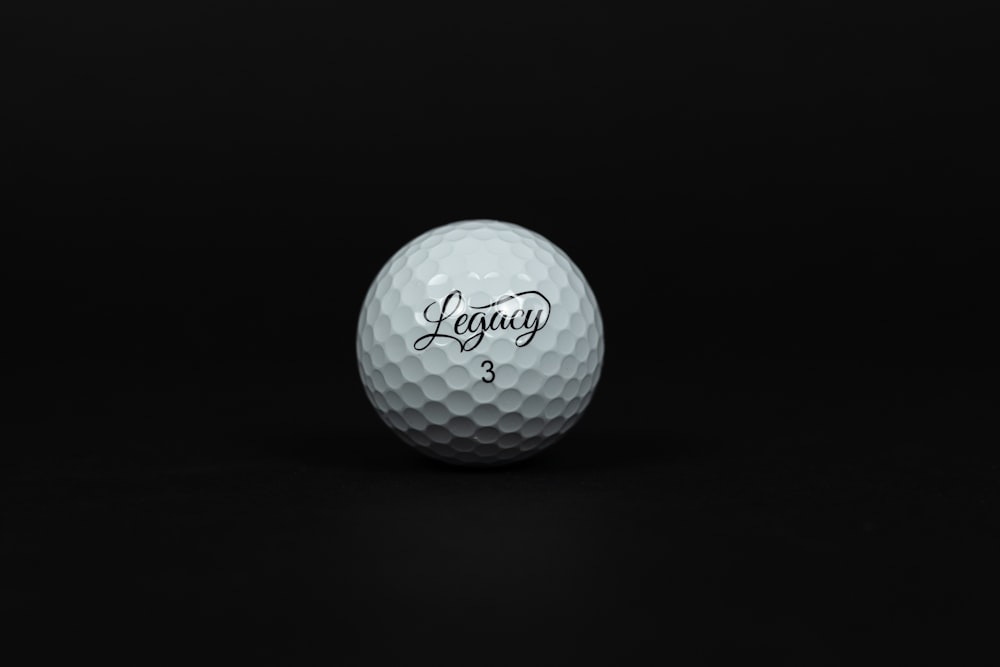 a white golf ball on a black background