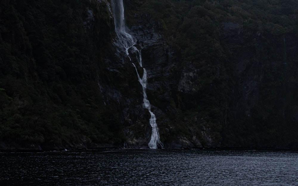 a waterfall in the middle of a body of water