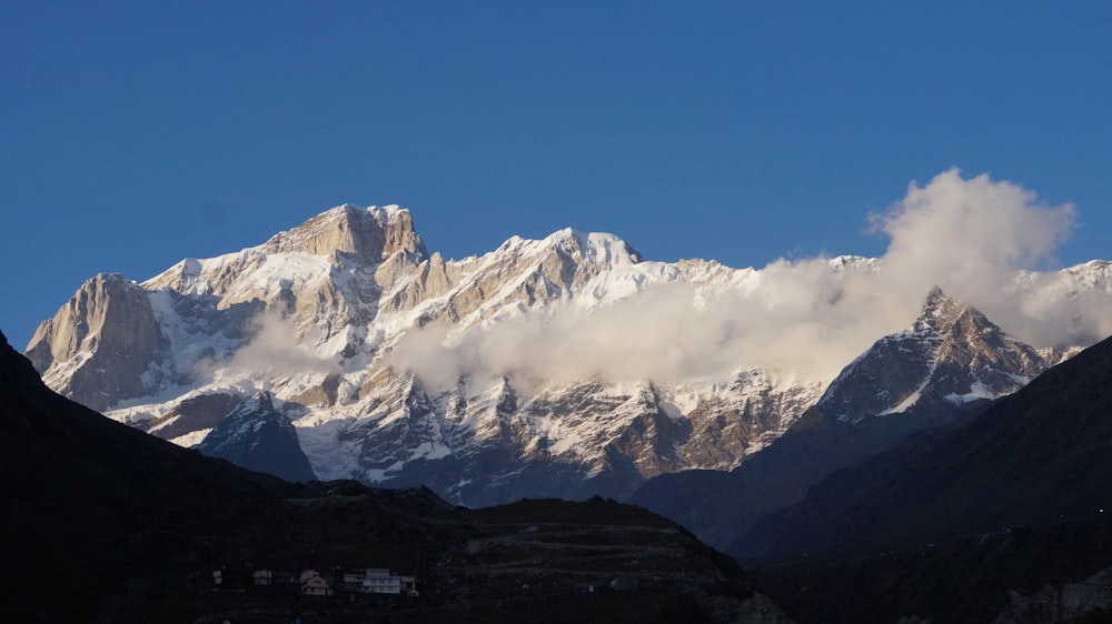 a view of a mountain range with clouds in the sky