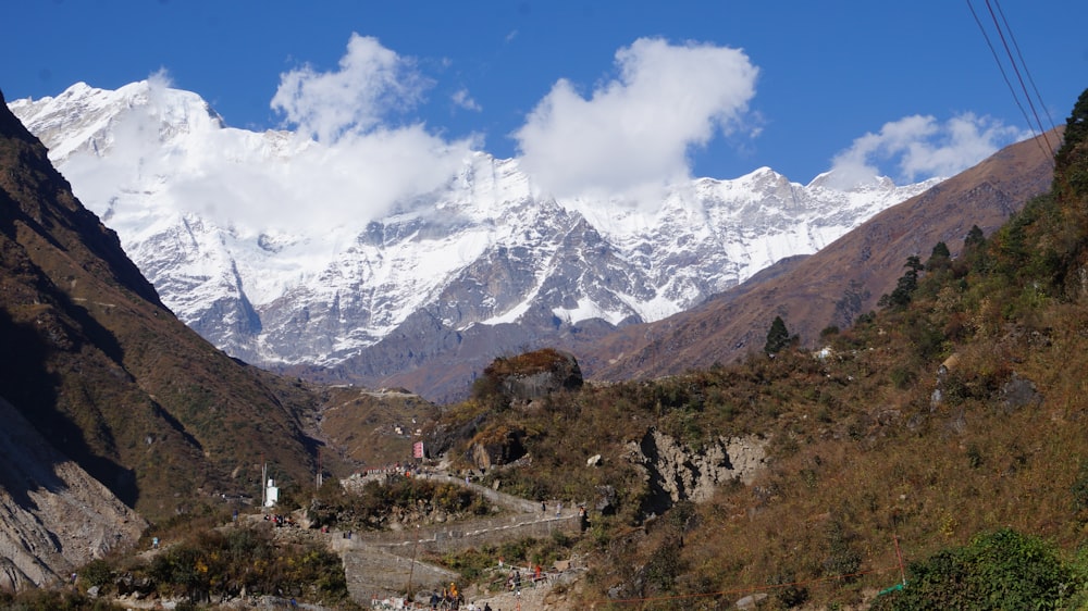 a view of a snowy mountain range from a trail